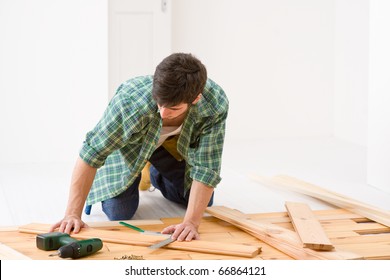 Home Improvement - Handyman Installing Wooden Floor