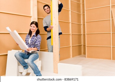 Home Improvement Happy Young Couple With Architectural Blueprints Fixing House