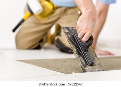 Home Improvement, Renovation - Handyman Laying Tile, Trowel With Mortar