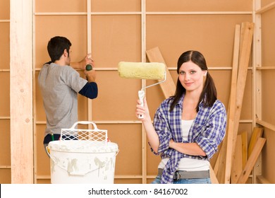 Home Improvement: Young Happy Couple Fixing New House Renovating Wall