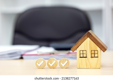 Home inspections, standard according to the requirements,  certifications, and real estate safety. Wooden house with check mark on the desk - Shutterstock ID 2138277163