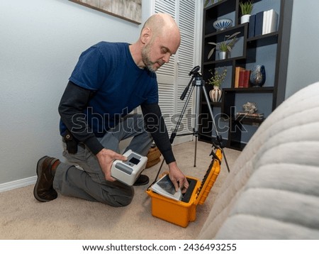 Home inspector doing a radon test setup in the lowest bedroom of a home.