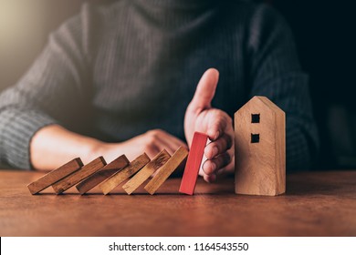 Home Insurance Ideas Concept With Man Hand Protect House Wooden Model From Risk And Problem