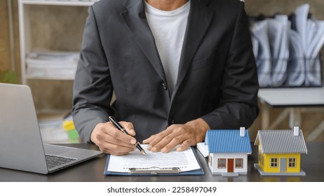 Home Insurance and Real estate investment concept,  new client after signing agreement contract with approved property application form. - Shutterstock ID 2258497049