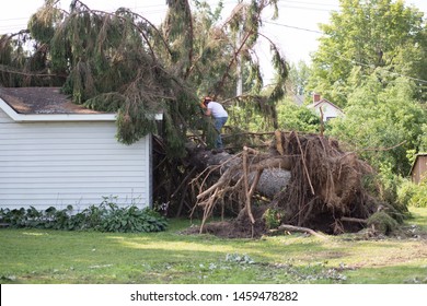 Home insurance. insurance storm.Storm damage.Roof damage from tree that fell over during hurricane storm.A storm causes a white oak tree to fall and rip through the roof of a house. A tree falls.