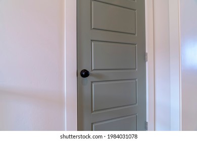 Home Interior With Close Up View Of The Gray Bedroom Door With Black Door Knob. The Door Is Installed Against The White Wall Of The House.