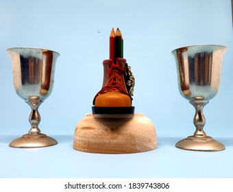 Home interior decor in gray   brown colors: candle holder silver jar   shoe shaped pencil holder the table and light background selective focus