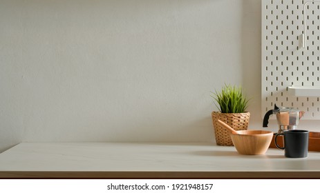 Home Interior Design With Mixed Bowl, Coffee Pot, Mug, Plant Pot And Copy Space On Kitchen Table