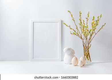 Home Interior With Easter Decor. Mockup With A White Frame And Willow Branches In A Vase On A Light Background