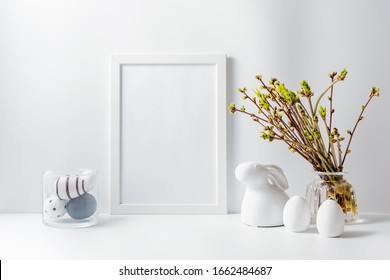 Home Interior With Easter Decor. Mockup With A White Frame And Green Buds On Branches In A Vase On A Light Background