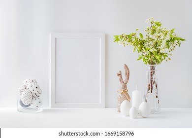 Home Interior With Easter Decor. Mockup With A White Frame And Spring Flowers In A Vases On A Light Background