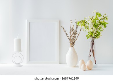 Home Interior With Easter Decor. Mockup With A White Frame And Spring Flowers In A Vases On A Light Background