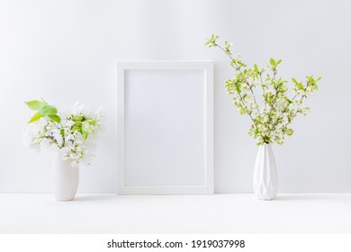 Home Interior With Easter Decor. Mockup With A White Frame And Spring Flowers In A Vase On A Light Background