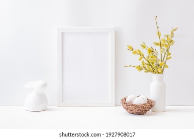 Home Interior With Easter Decor. Mockup With A White Frame And Willow Branches In A Vase On A Light Background