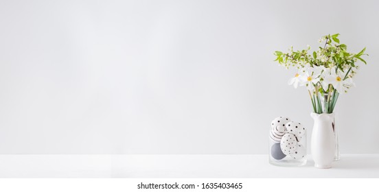 Home Interior With Easter Decor. Spring Flowers In A Vase And Easter Eggs On A Light Background