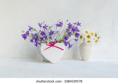 Home Interior And Garden Concept With Summer Flowers In A Metal Bucket On A Light Background