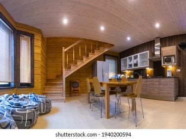 Home Interior. Interior Of A Private House Made Of Wood. Concept - Interior Design Of A Private House. Combined Kitchen And Dining Room In  House. The Beanbag Chairs Are By The Window.