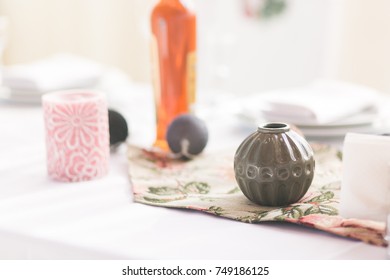 Home interior table scene, front view, with decor elements, round vase, garland balls, candles and blank copy, logo space on white background.
