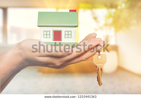 Home key in house keychain on woman/ man/ human
hand support offering security protection awareness concept:
Insurance agent in white shirt holding happy residential key lock/
unlock insure habitat