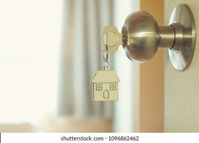 Home key with metal house keychain in keyhole, property concept - Shutterstock ID 1096862462
