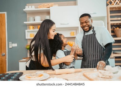 In a home kitchen, black father and his daughter bond over cooking a meal food, their laughter and love filling the air, embodying the joy of African American family life, Father's Day concept - Powered by Shutterstock