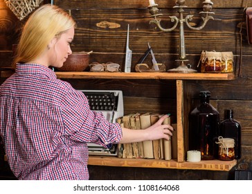 Home Library Concept. Girl Looking For Book In House Of Gamekeeper. Lady Blonde In Plaid Clothes Taking Book From Bookshelf. Girl In Casual Outfit In Wooden Vintage Interior Enjoy Literature.