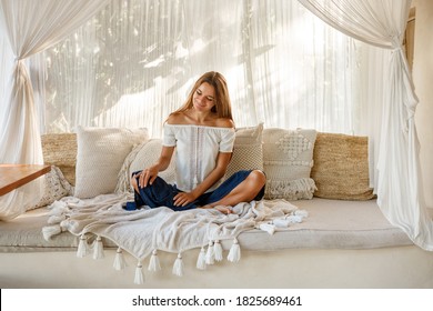 Home Lifestyle Woman Relaxing Enjoying Luxury Sofa Patio Furniture On Outdoor Patio Living Room. Young Woman Sitting On Chair In Green Garden Terrace