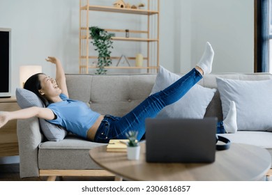 Home lifestyle woman relaxing sleeping on sofa  patio living room. Happy lady lying down on comfortable pillows taking a nap for wellness and health. Tropical vacation