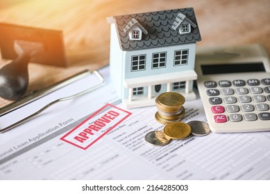 Home Loan Approved On Loan Application Form Paper With Rubber Stamp Calculator Coin And Loan House Model On Table, Loan Approval Business Finance Economy Commercial Real Estate Investments Concept