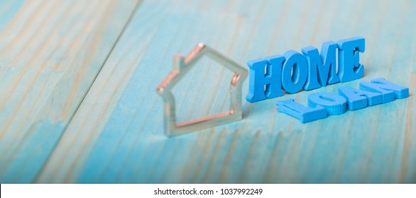 Home loan words with metal shape house on wooden table top
