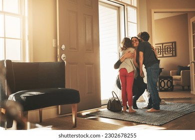Home, love and a mother hugging her kids after arriving through the front door after work during the day. Greeting, family or children with a woman holding her son and daughter in the living room