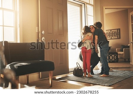 Home, love and a mother hugging her kids after arriving through the front door after work during the day. Greeting, family or children with a woman holding her son and daughter in the living room
