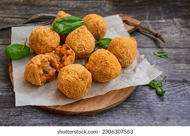  Home made Arancini bolognese . Italian fried rice balls with mozzarella cheese  minced meat  and fresh parsley. Italian street food. - Powered by Shutterstock