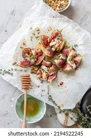 Home made Baked figs with goat cheese, pistachios, honey and thyme for wine pairing - Shutterstock ID 2194522245