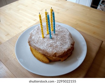 A home made birthday cake with candles - Shutterstock ID 2295022155