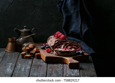 Home made 'Black Forest' roll cake Buche de Noel decorated with berries and served with Coffee - Shutterstock ID 758829217