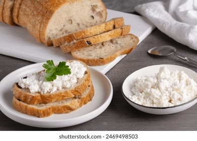 Home made bread on a wooden cutting board with curd cheese