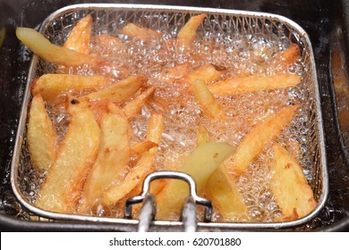 Home Made Chips In A Hot Deep Fryer With Boiling Oil