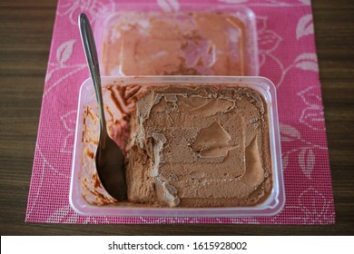 Home Made Chocolate Ice Cream With A Spoon Inside A Container