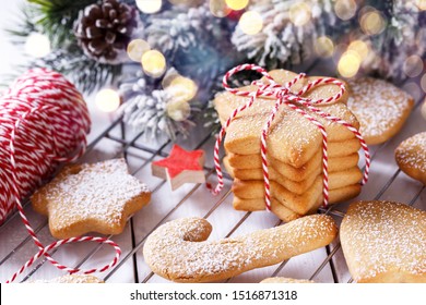 Home made Christmas shortbread or gingerbread cookies on a white wooden surface, horizontal