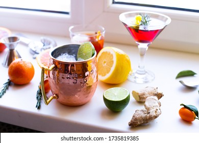 Home Made Cocktails Ingredients Blood Orange Lemon Lime Ginger Herbs And Martini Moscow Mule Cocktails On White Background. Backdrop For Social Media Network Blogs Drink Recipe Posts