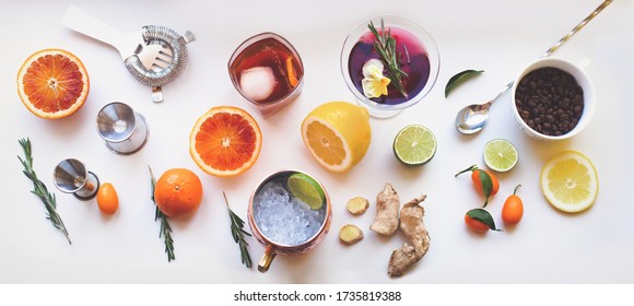 Home Made Cocktails Ingredients Blood Orange Lemon Lime Ginger Herbs And Martini Moscow Mule Cocktails On White Background. Backdrop For Social Media Network Blogs Drink Recipe Posts