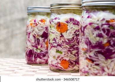 home made cultured or fermented vegetables in jars with more in the background