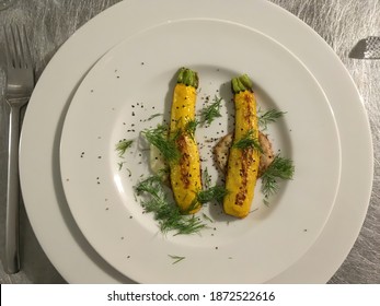 Home Made Dish With Grilled Yellow Zucchini Squash Halves On Two Different Sauces Garnished With Dill And Black Pepper Served On A White Porcelain Plate