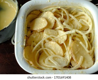 Home Made Easter Dinner Scalloped Potatoes With Thinly Sliced Onions Ready For Oven. Shot From Above