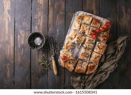 Focaccia bread with knife and olive oil