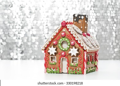 Home Made Gingerbread House With A Silver Background