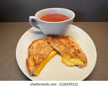 Home Made Grilled Cheese Sandwich With A Cup Of Tomato Soup. 