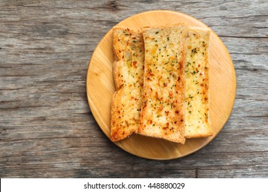 Home Made Herb And Garlic Bread On Wood Table Top View.