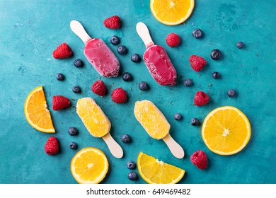 Home Made Ice Cream With Berries, Orange Over Blue Wooden Background. Top View